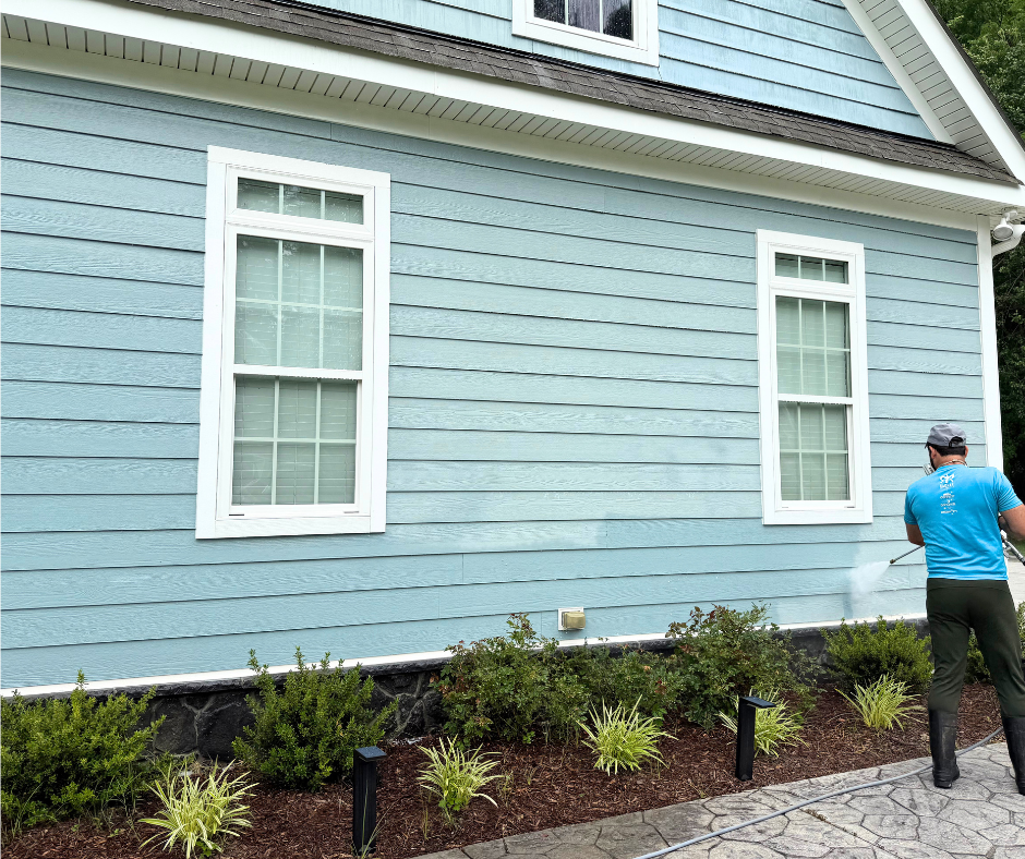 professional cleaner washing home exterior